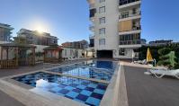 AL-2166, Nur 150 m vom Strand entfernt – möblierte 60 m² große 1+1-Wohnung mit Fußbodenheizung, Pool, Sauna und Fitnessraum, Kargıcak