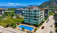 AL-2169, Blick auf das Meer, den Pool und die Berge von einem riesigen Balkon aus – möblierte 72 m² große 1+1-Wohnung mit Sauna und Fitnessbereich, Kestel