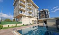AL-2182, Nur 300 m vom Strand entfernt – möblierte 60 m² große 1+1-Wohnung mit Innenpool, Sauna und Fußbodenheizung, Kargıcak